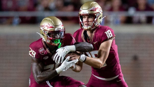 Florida State quarterback Tate Rodemaker, right, hands the ball to running back Rodney Hill.